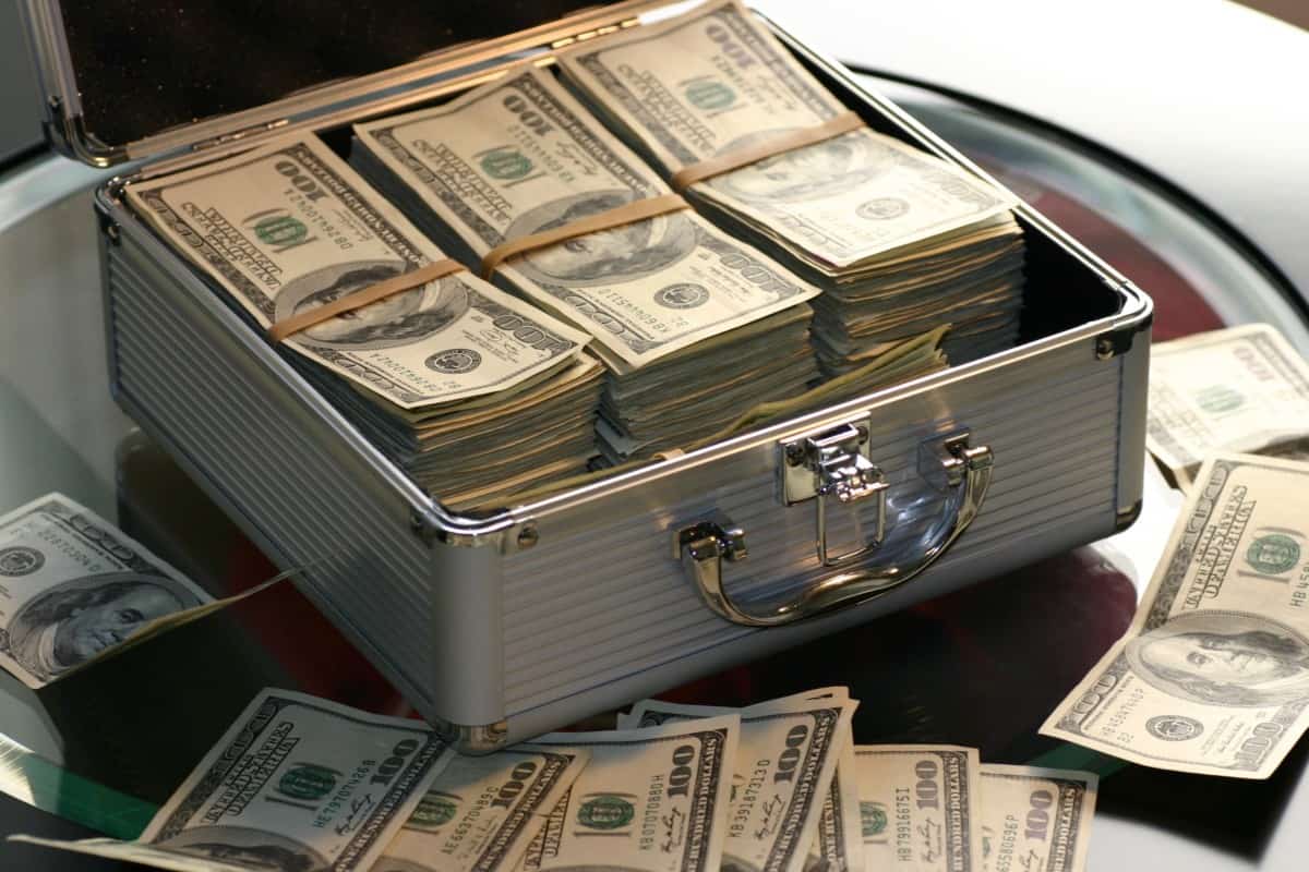 A case full of money sitting on a table.